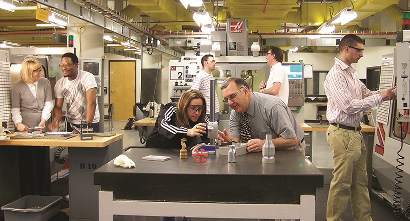 Image of students and faculty working in the mechanic engineering facility